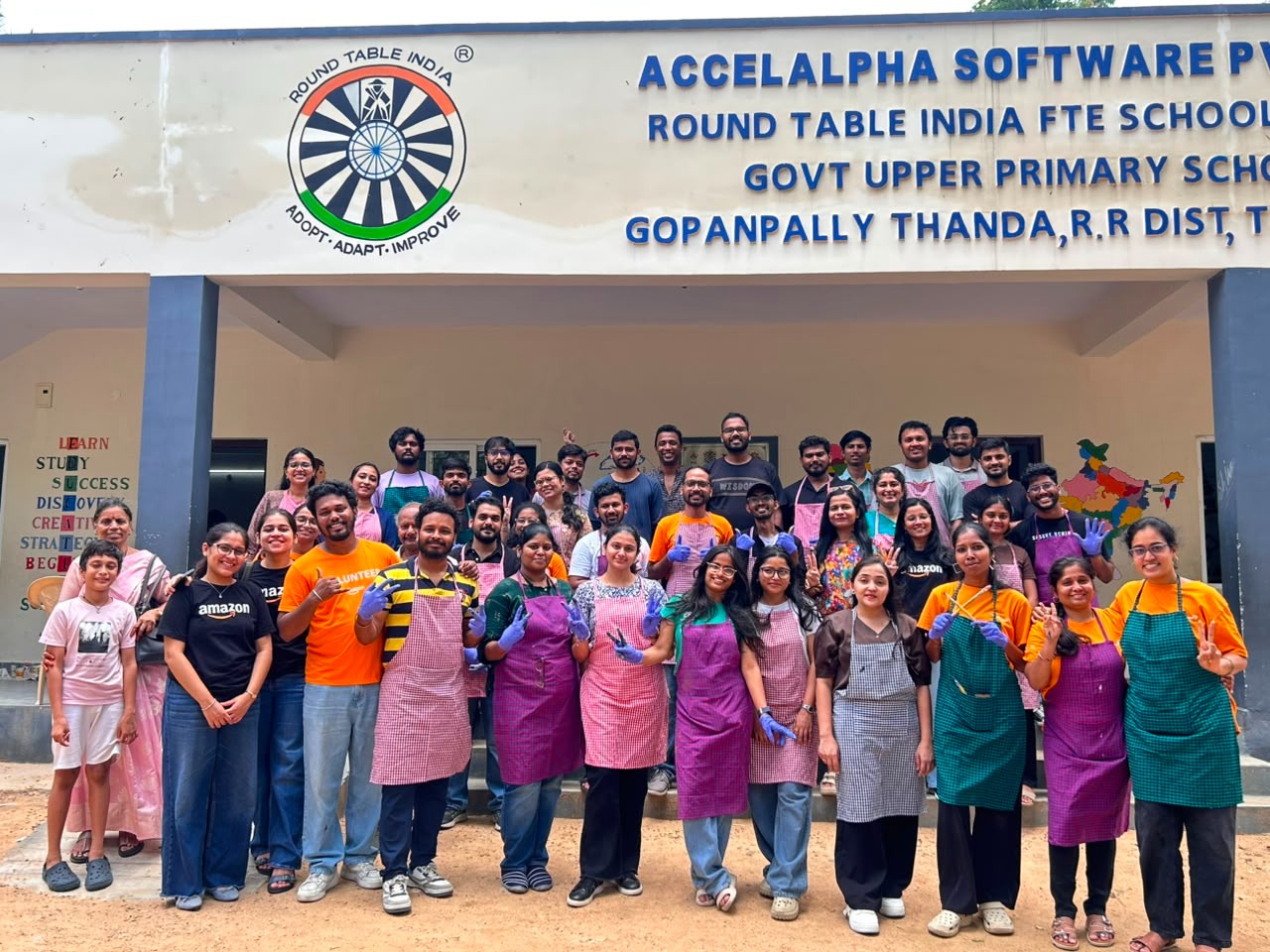 LLI volunteers in aprons outside Gopanpally Thanda Government School